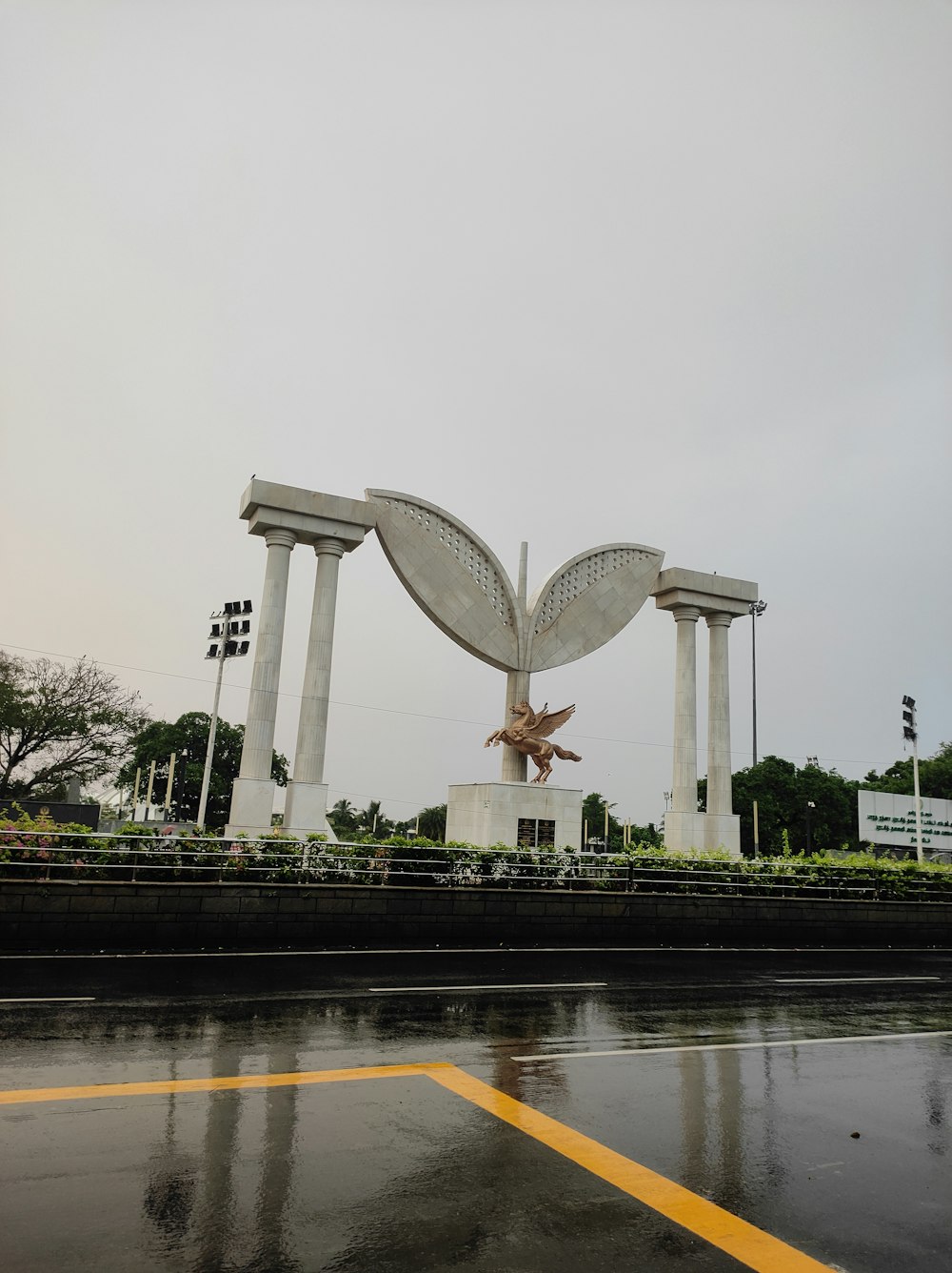 a large statue of a bird in the middle of a road