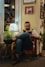 a man sitting in a chair reading a book