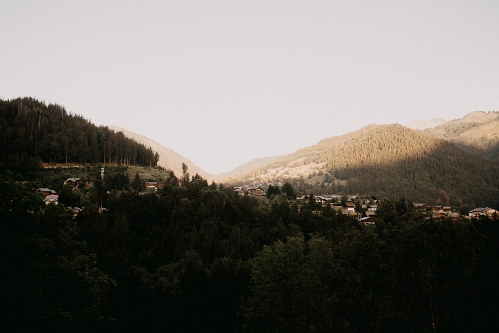 a view of a town nestled in the mountains