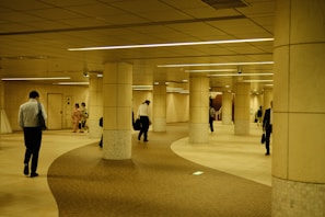 a group of people walking around a building