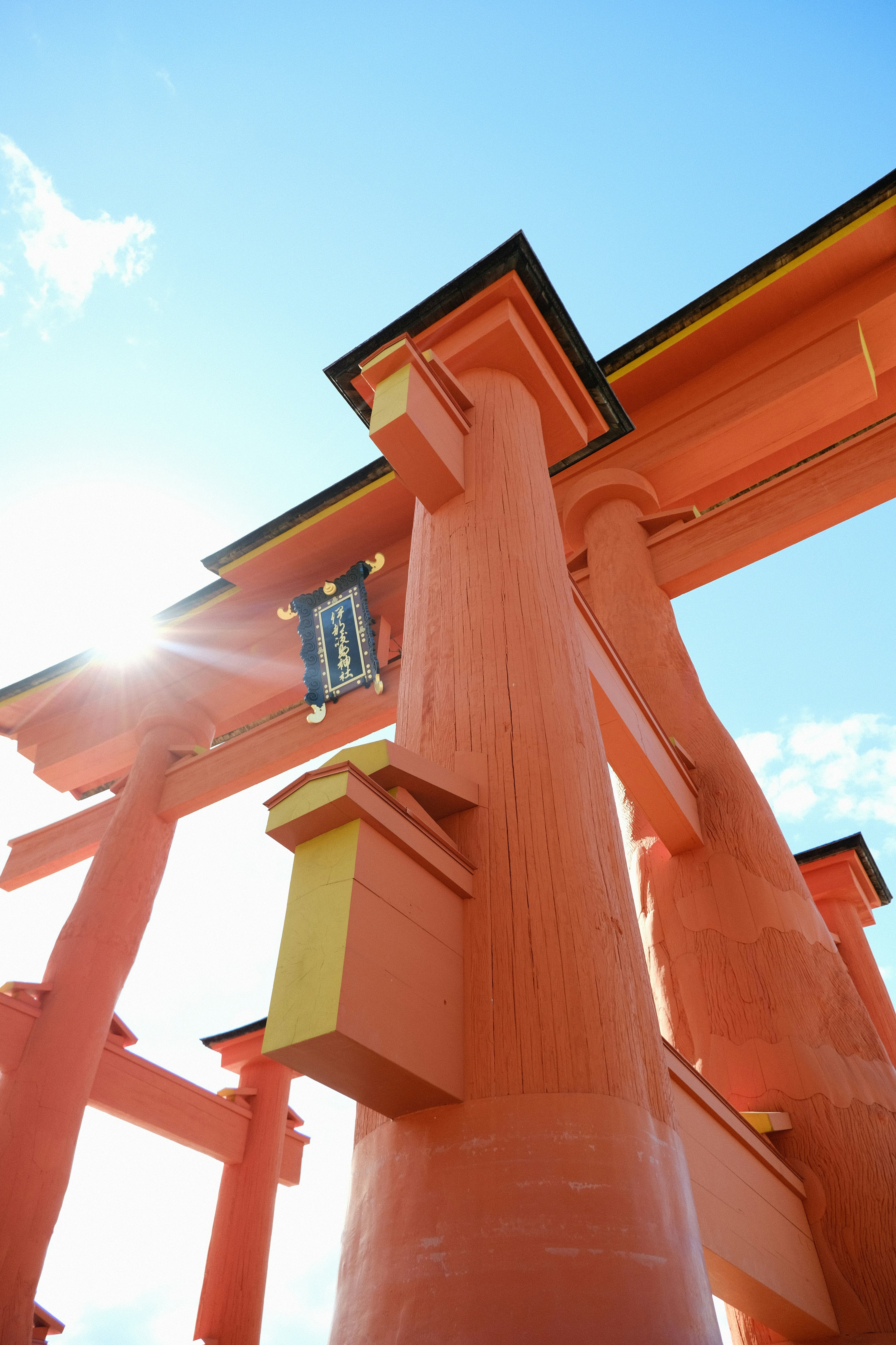a tall orange structure with a clock on it's side