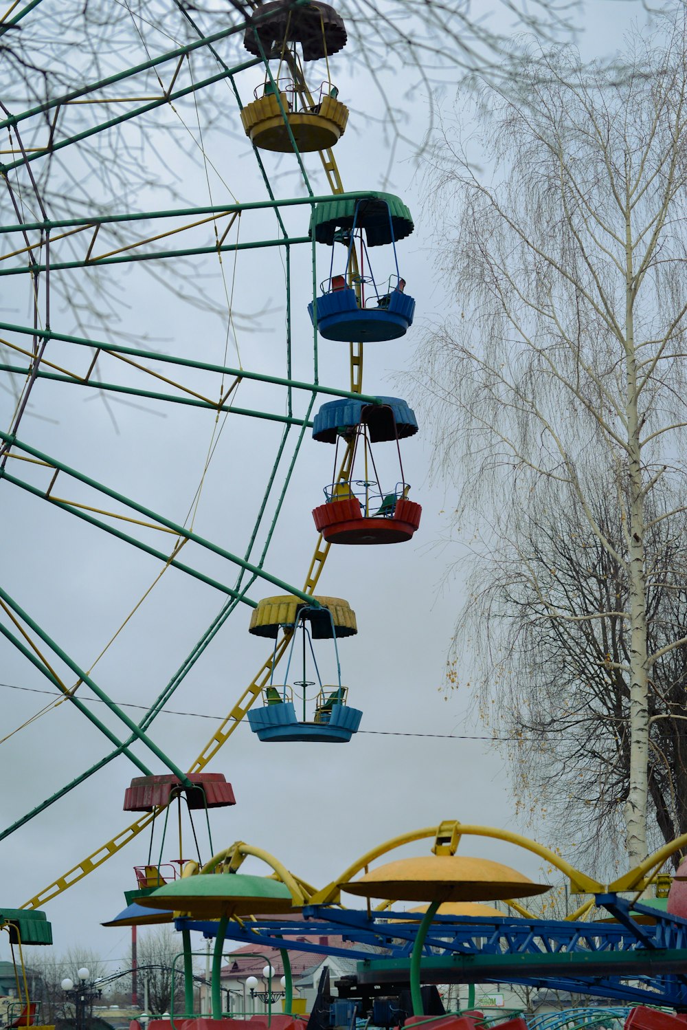 a ferris wheel with colorful seats hanging from it