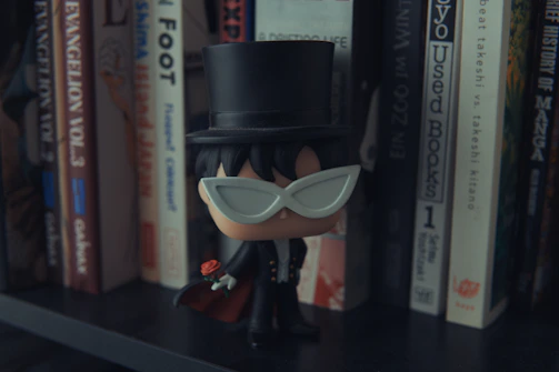 A tiny robot in a tuxedo shaking its butt while holding a champagne glass.