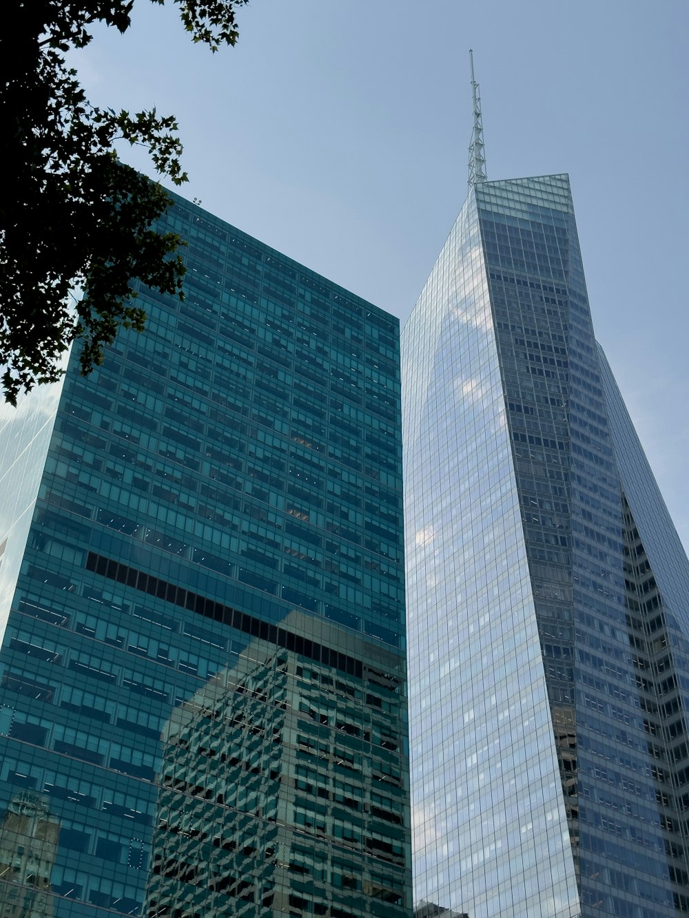 a couple of tall buildings sitting next to each other