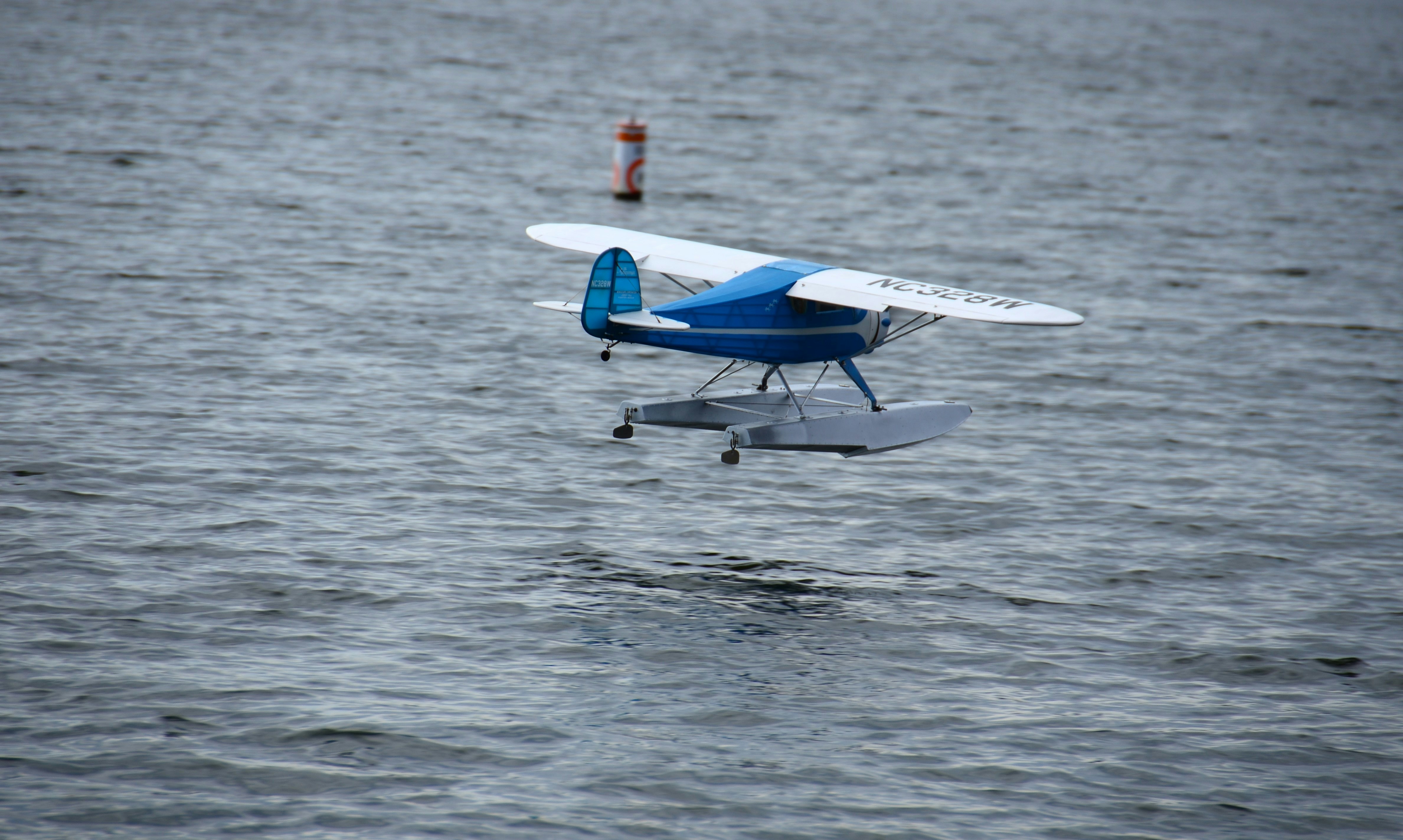 a small plane flying over a body of water