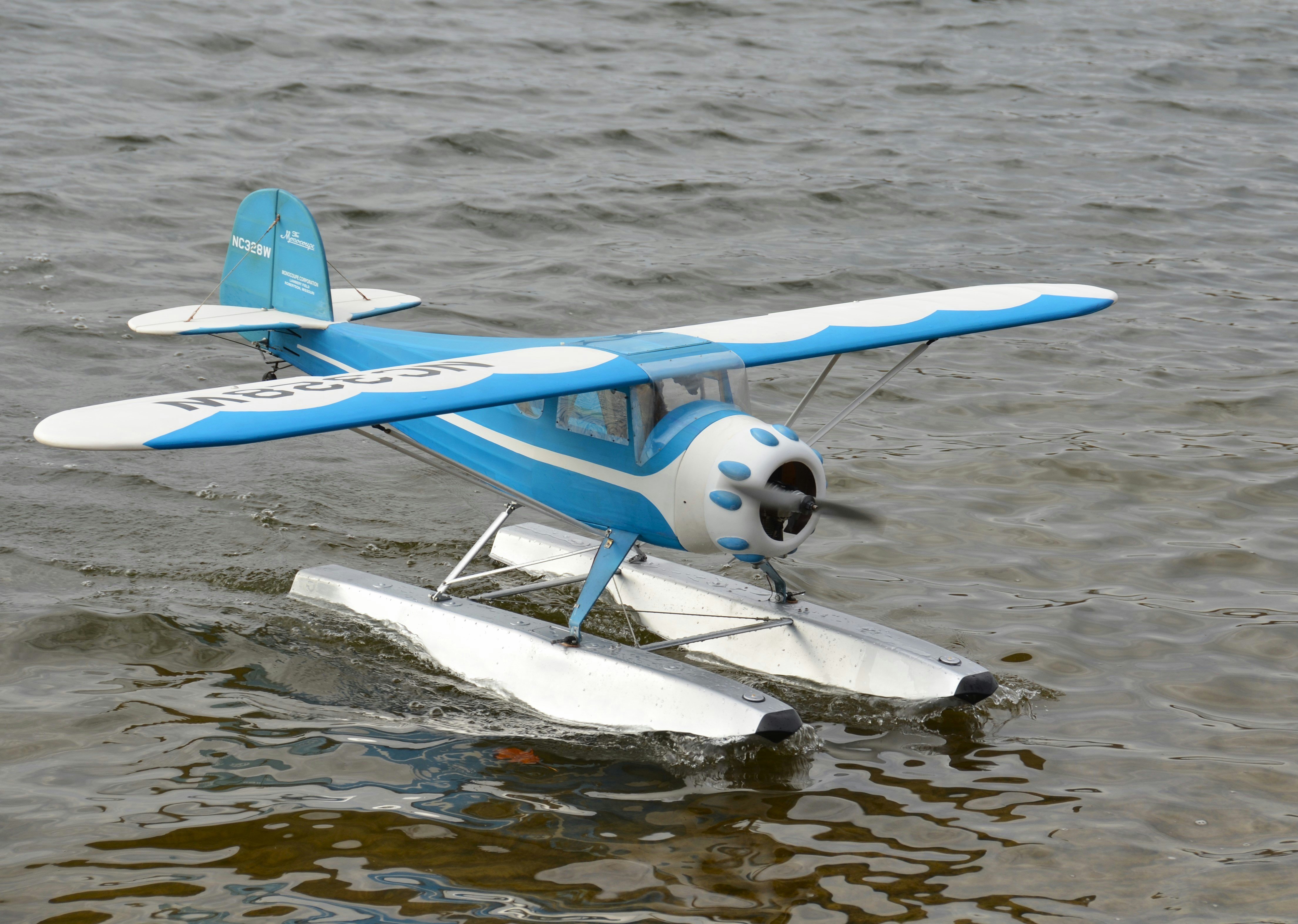 a small blue and white plane in the water