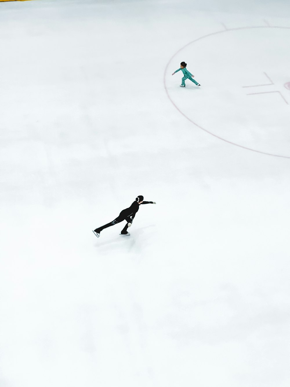 a man riding a snowboard down a snow covered slope