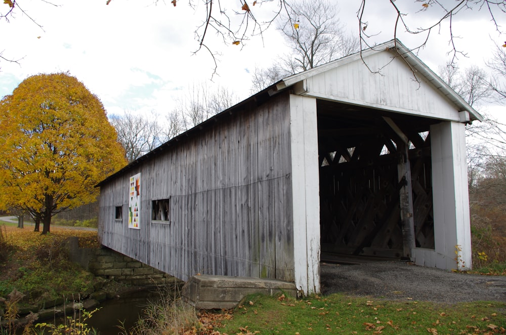 a covered bridge with a sign on the side of it