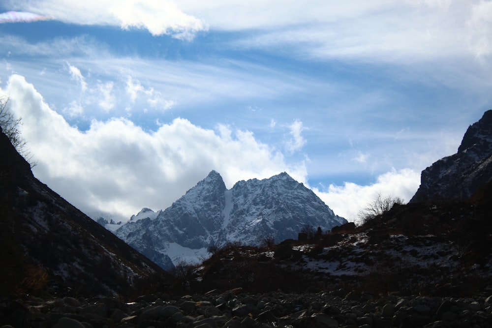 a view of a mountain range with clouds in the sky