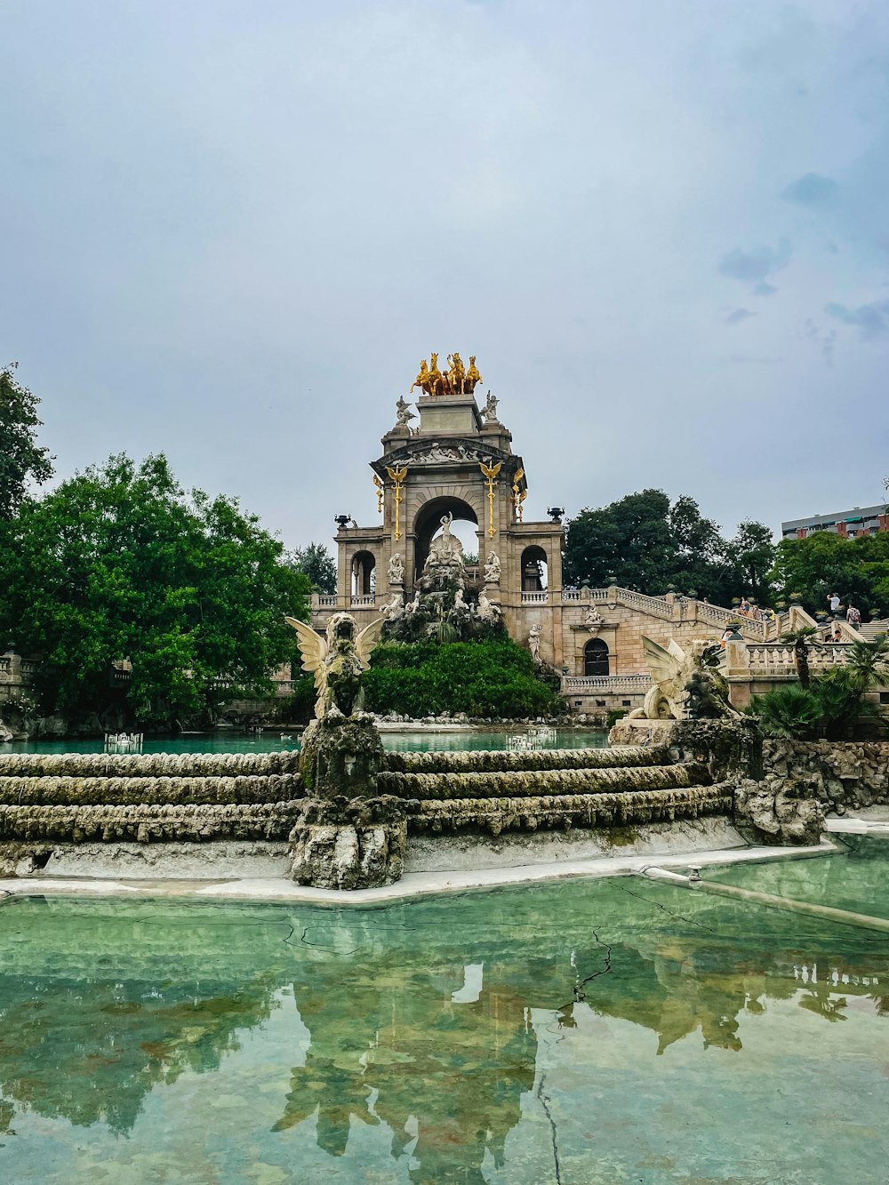 a large fountain with statues on top of it