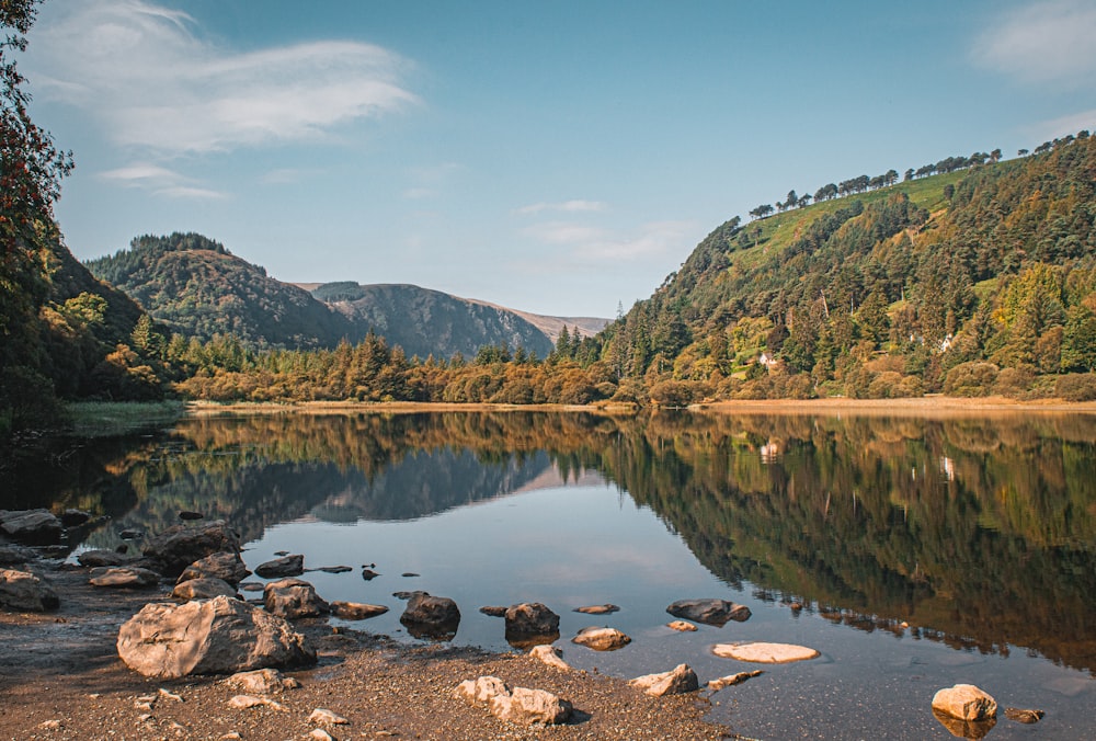 a body of water surrounded by mountains and trees