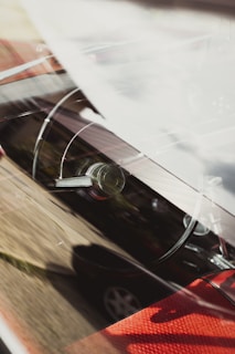 A close-up of a shiny car dashboard with Senegalese scenery reflected in the windshield.