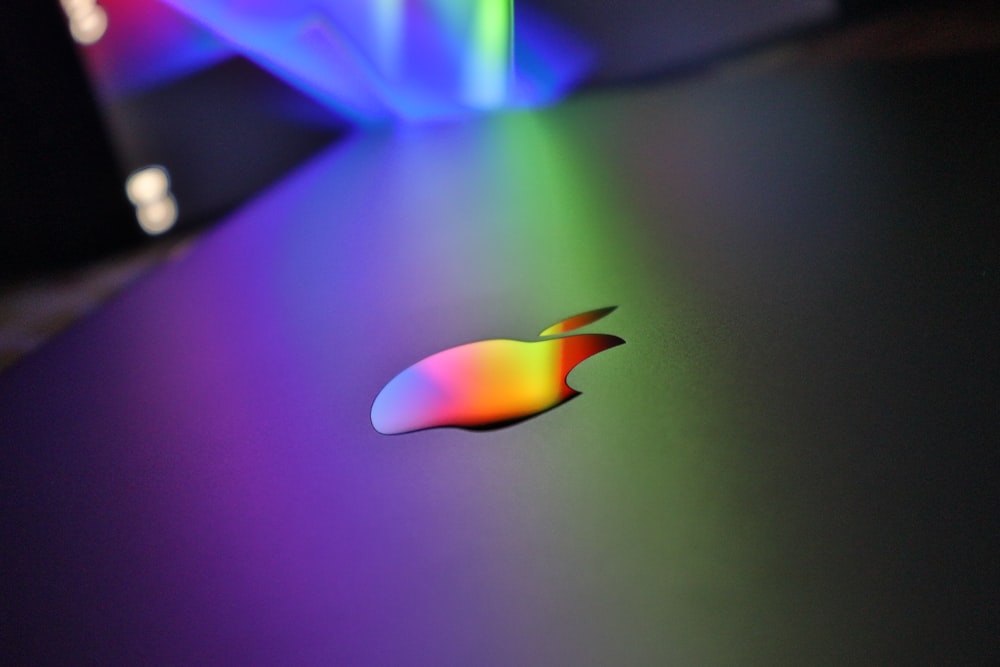 a close up of an apple logo on a table