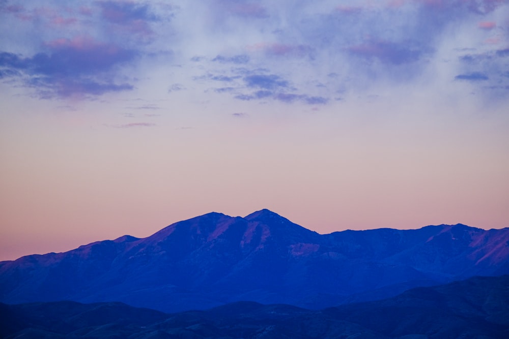 a plane is flying over a mountain range