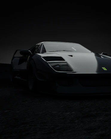A sleek black sports car captured with dramatic lighting highlighting its curves.