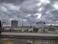 Industrial-scale sulphur storage tanks under a steel grey sky at the Ketovia Agri Chem facility.
