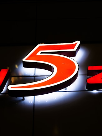 a lighted sign with the number five on it