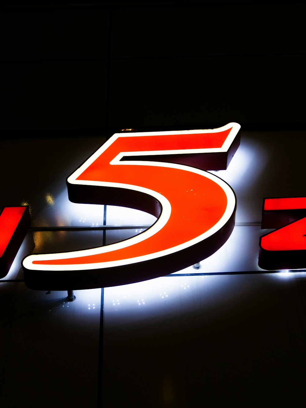 a lighted sign with the number five on it