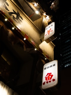Close-up of illuminated signage panels glowing at night.