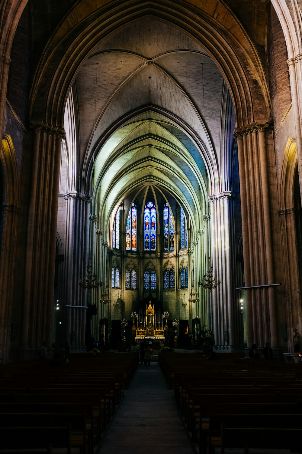 a large cathedral with stained glass windows and pews