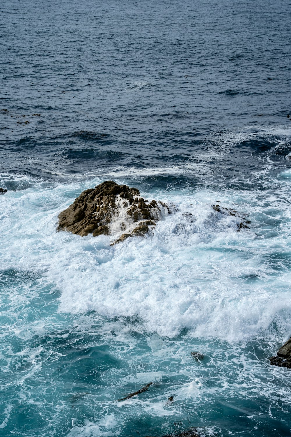 a rock in the middle of a body of water