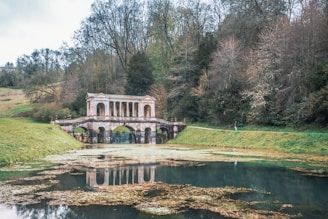 a large building sitting on top of a lush green field