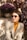 a woman sitting on a bench wearing sunglasses