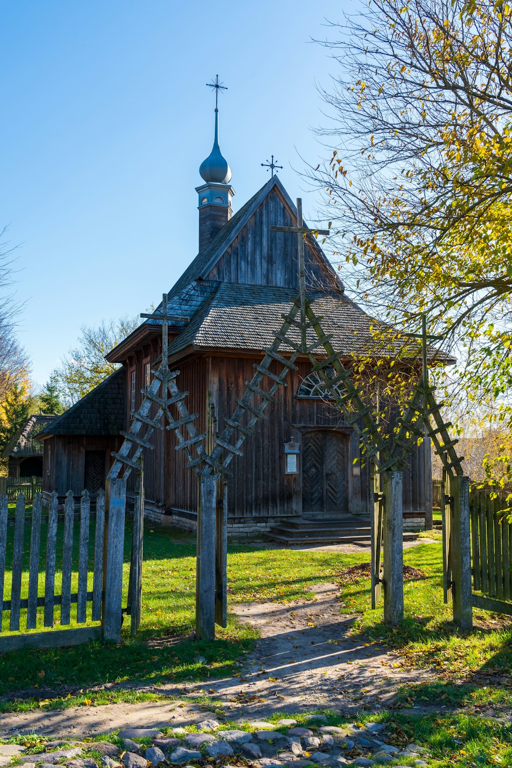 an old wooden church with a steeple on top