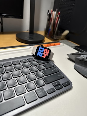 A colorful digital clock with multiple functions displayed on a kitchen counter.