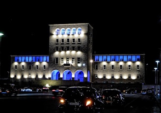 a building lit up with blue lights at night