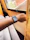 Close-up shot of a man showing off his smartwatch with a satisfied smile in a cozy indoor setting