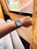 A patient using a therapeutic device for hand and wrist relief in a bright room.