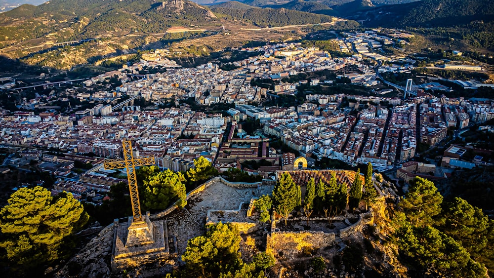 an aerial view of a city with mountains in the background