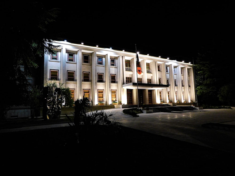 a large white building lit up at night