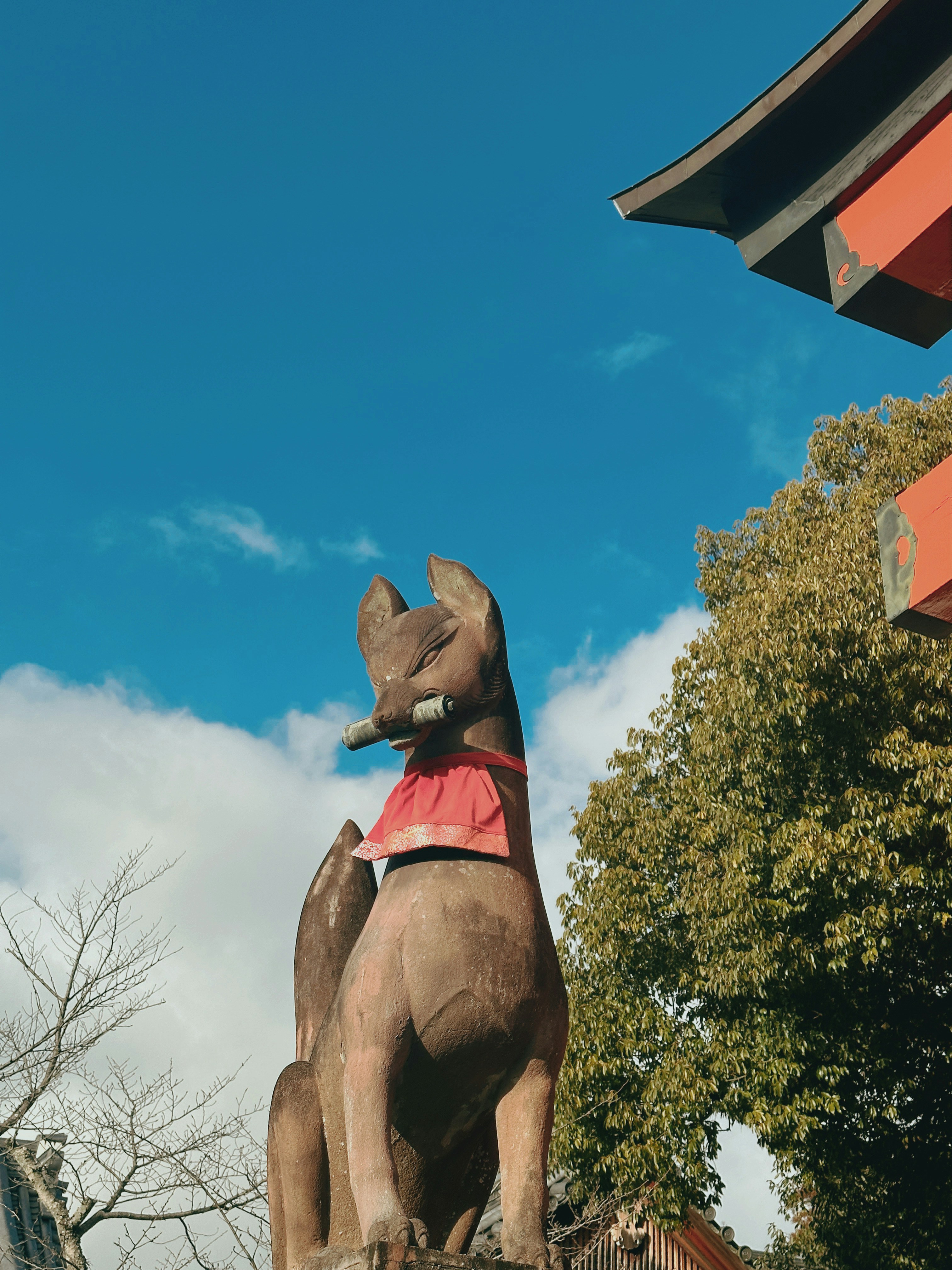 a statue of a dog wearing a red shirt