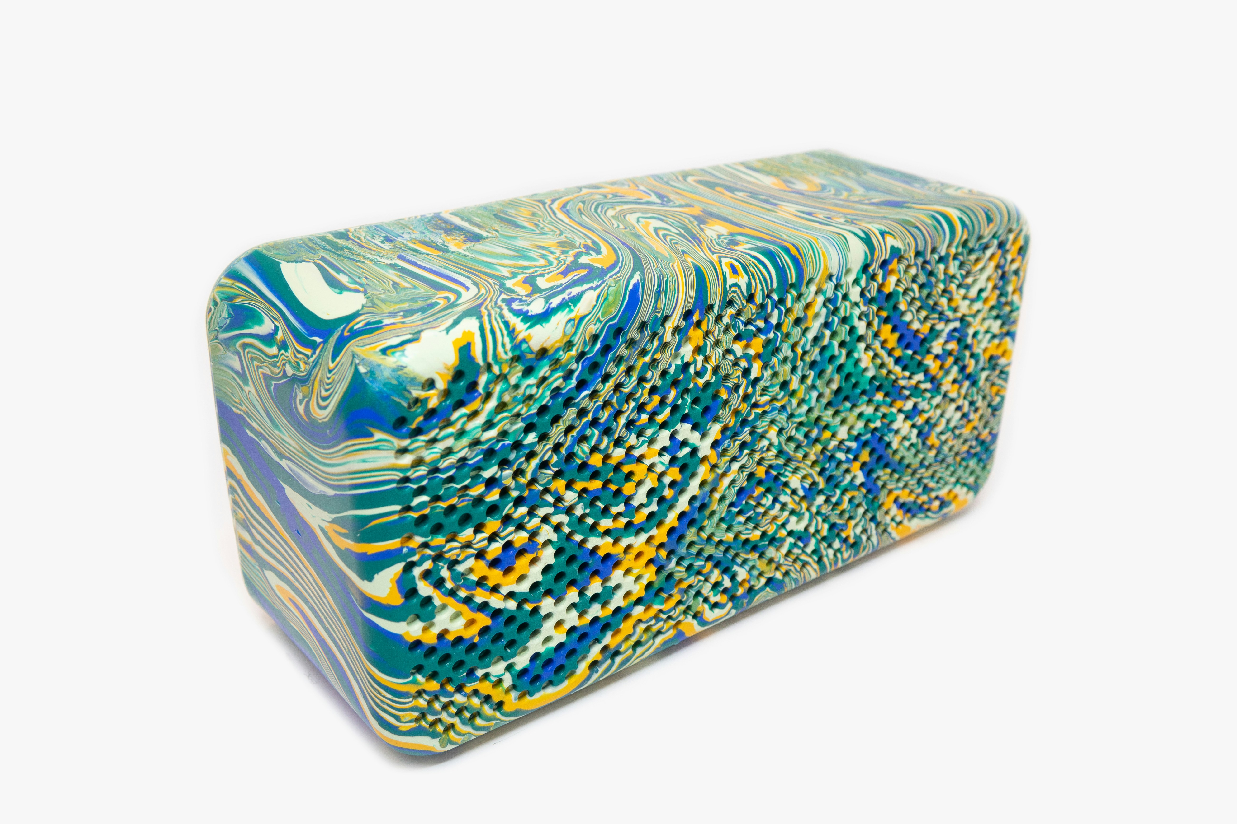a blue, yellow, and green box sitting on top of a white surface