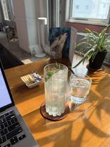 A cozy Nordic-style workspace with fresh fruits and beverage ingredients on the table.