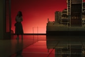 An architect presenting a building model to clients in a bright meeting room.