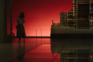 Portrait of architect Michael Mirasol reviewing detailed architectural plans in a bright studio.