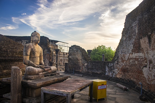 A peaceful scene of a donation box with offerings placed by visitors in front of a Buddha shrine.