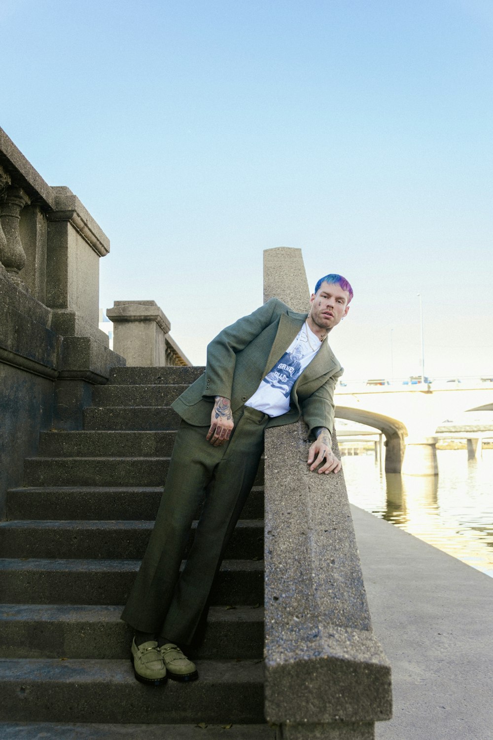 a man in a suit sitting on some steps