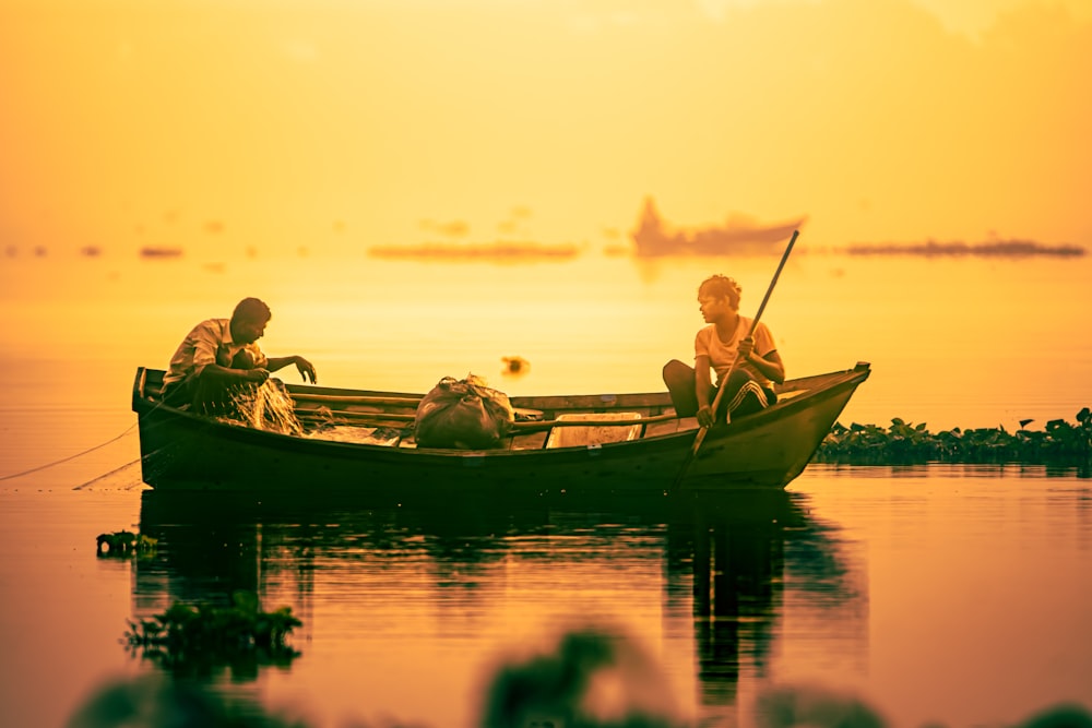 two people in a boat on a body of water