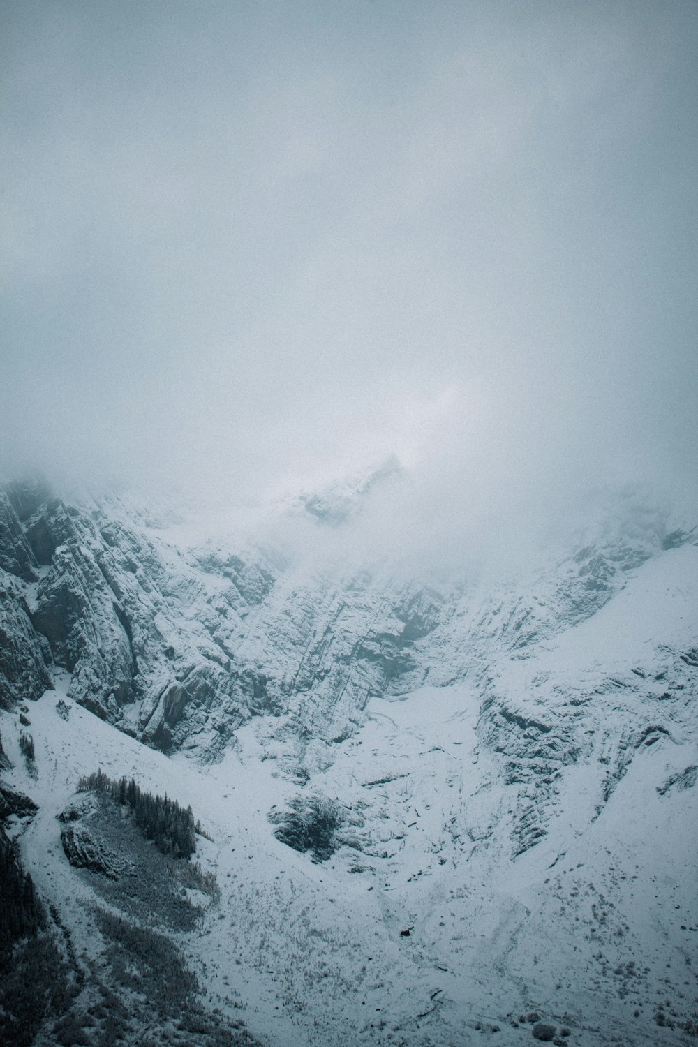 a mountain covered in snow with a sky background