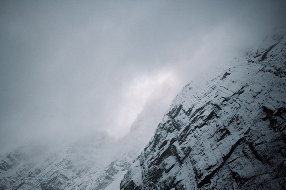 a snowboarder is going down a snowy mountain