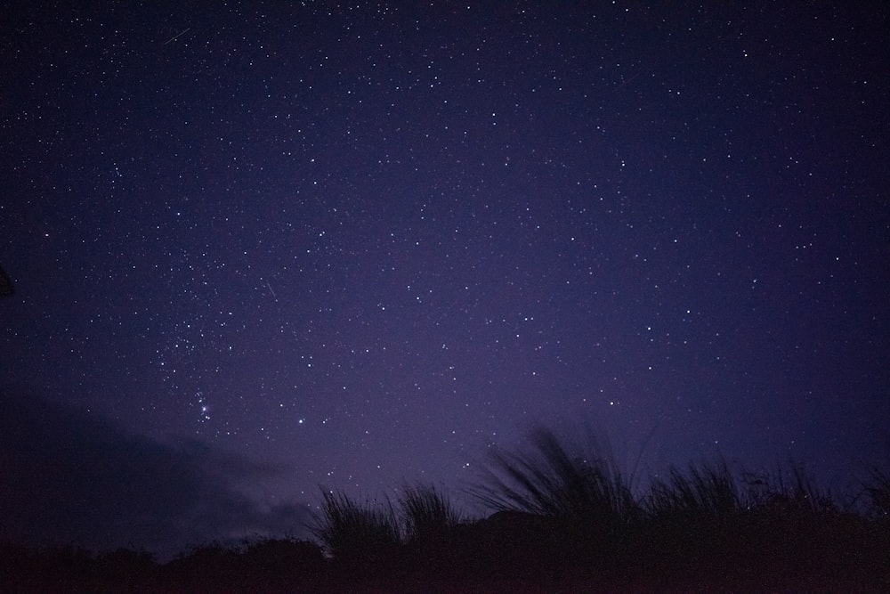 the night sky is filled with stars and clouds