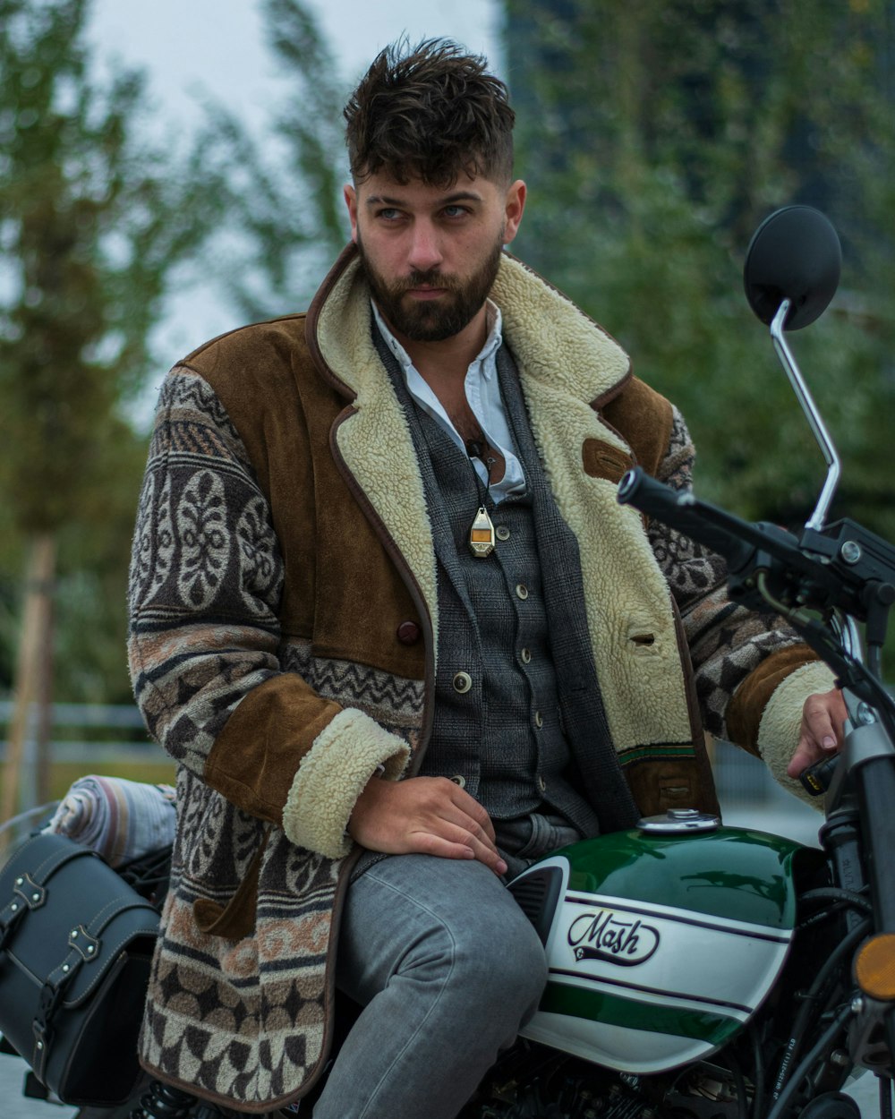 a man sitting on the back of a motorcycle