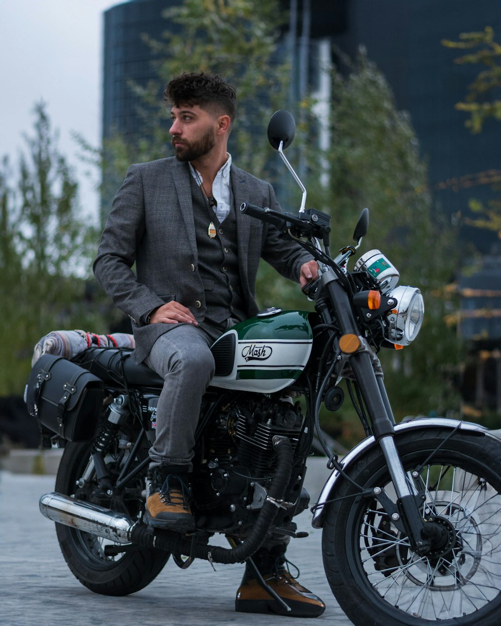 a man in a suit sitting on a motorcycle