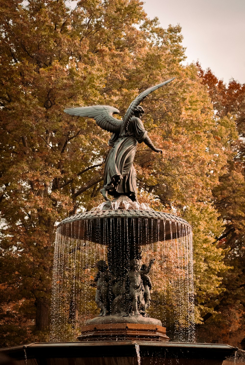 a statue of an angel on top of a fountain