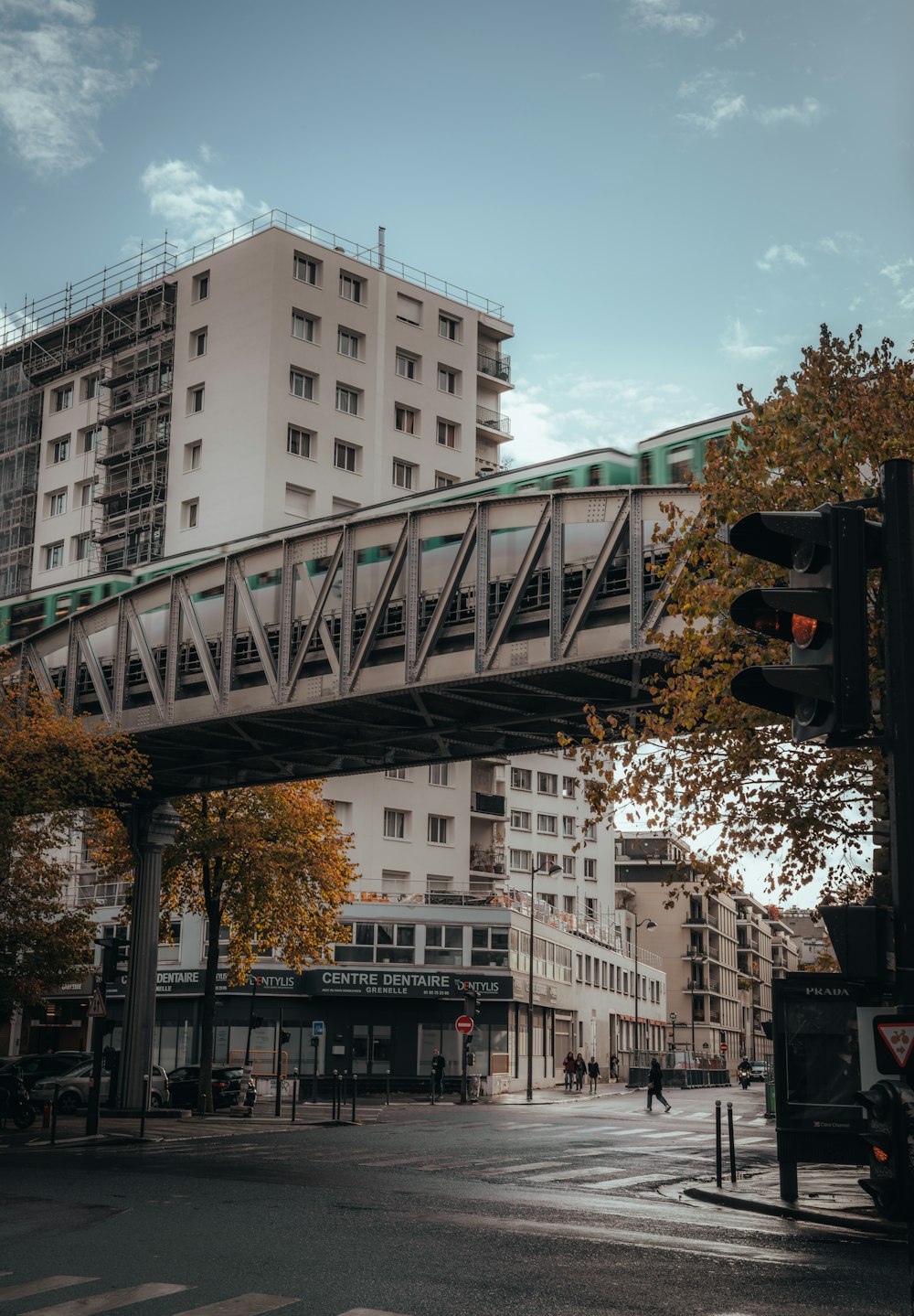 a train crossing a bridge over a city street