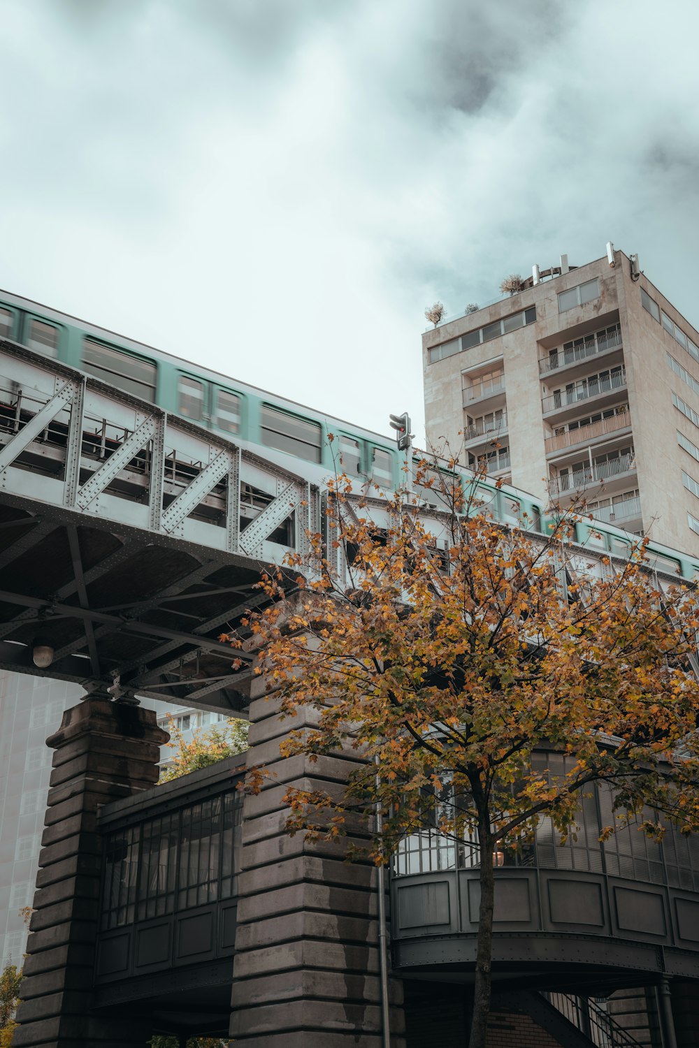 a bridge over a river with a building in the background